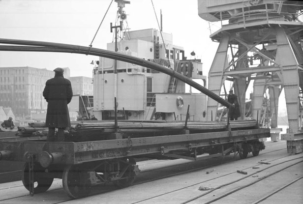 Steel rods being unloaded from mv 'Pluto'