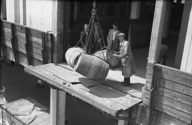 Barrels being lowered by crane