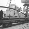 Steel rods being unloaded from mv 'Pluto'