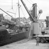 Combine havester lowered onto flatbed