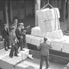 Transferring bales of woodpulp into shed by motor trolley, 3 June 1947